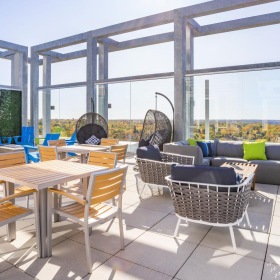 A new standard of living a patio with tables and chairs