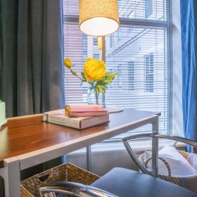 Refined spaces to match your style a table with a lamp and a vase of flowers on it